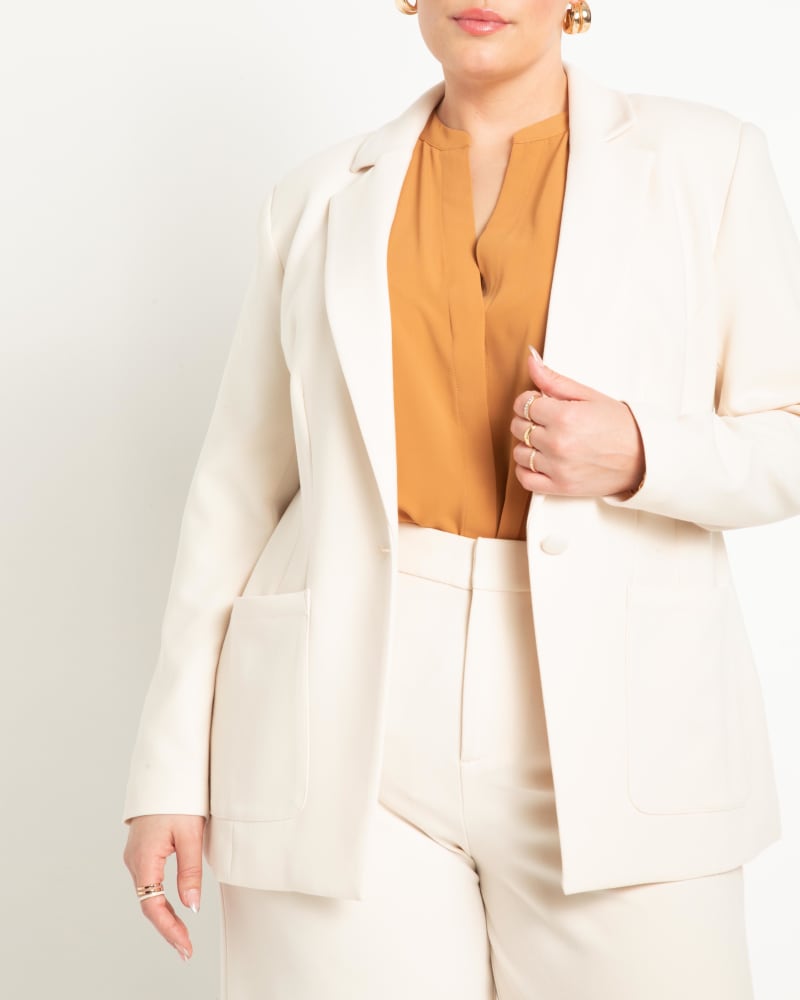 Front of a model wearing a size 18 The 365 Suit Patch Pocket Blazer in White Swan by ELOQUII. | dia_product_style_image_id:272986